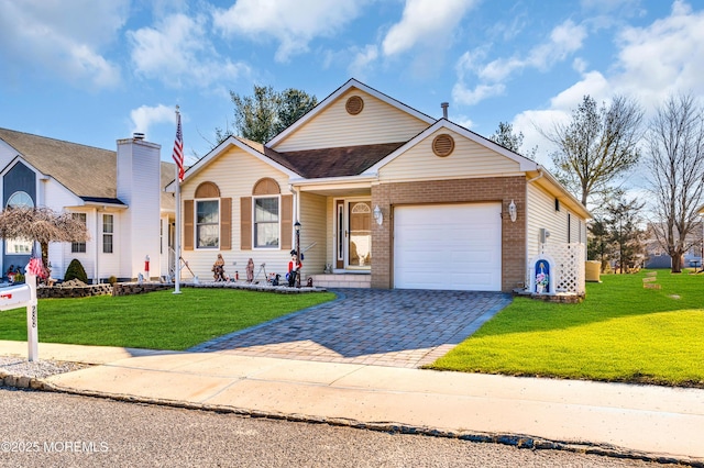 view of front of property featuring roof with shingles, an attached garage, decorative driveway, a front lawn, and brick siding