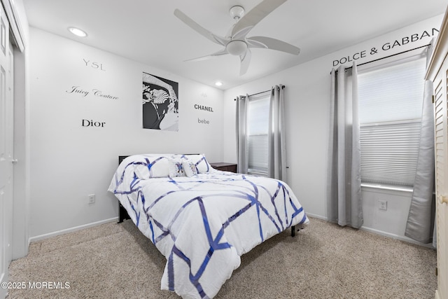 bedroom featuring a ceiling fan, recessed lighting, light colored carpet, and baseboards