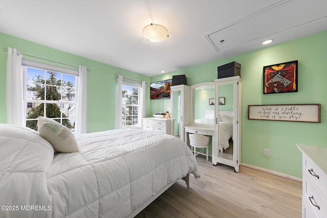 bedroom featuring light wood-style flooring and baseboards