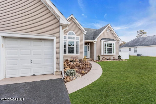 view of property with a front lawn and a garage