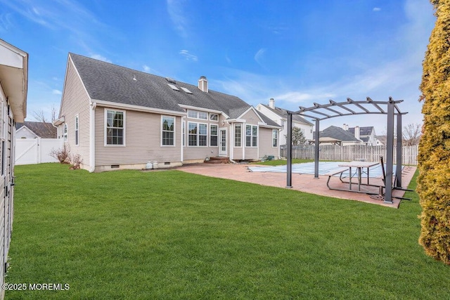 back of house with a patio area, a yard, and a pergola