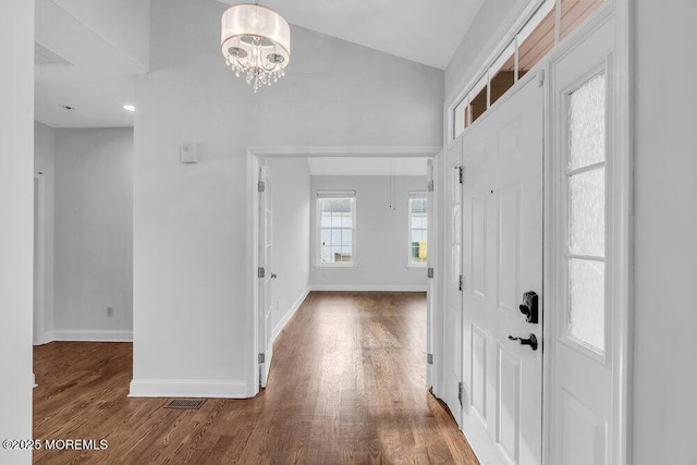 foyer entrance with an inviting chandelier and wood-type flooring