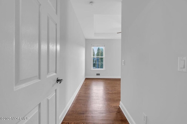 corridor featuring dark hardwood / wood-style floors