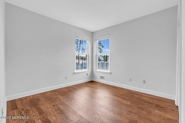 unfurnished room featuring wood-type flooring