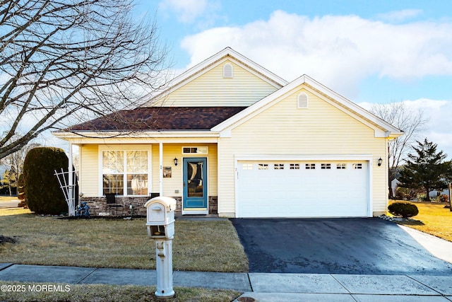 view of front of property with a front lawn and a garage