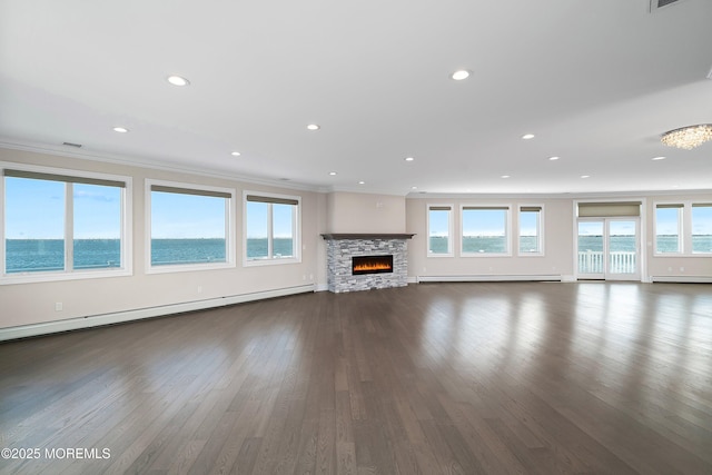 unfurnished living room featuring baseboard heating, a water view, crown molding, and dark hardwood / wood-style floors