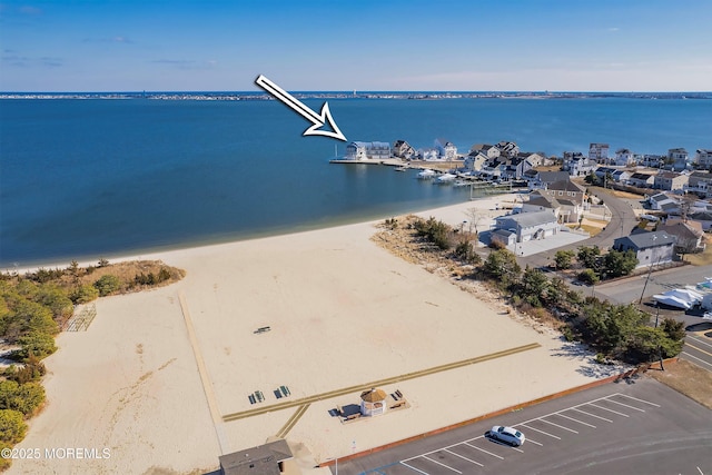 bird's eye view with a water view and a view of the beach