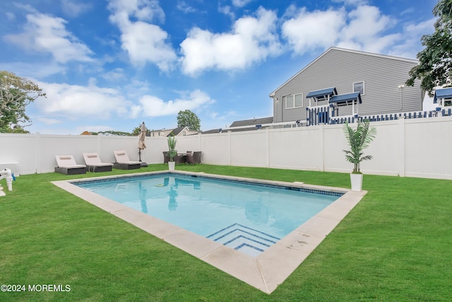 view of swimming pool featuring a lawn