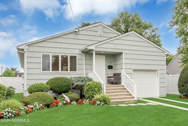 view of front of property with a front lawn and a garage