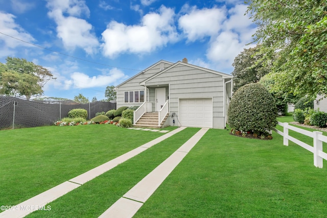 view of front of property featuring a garage and a front lawn