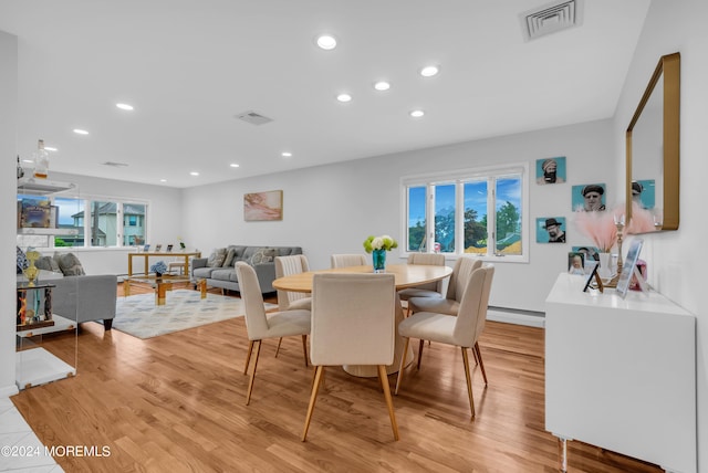 dining space with light hardwood / wood-style flooring