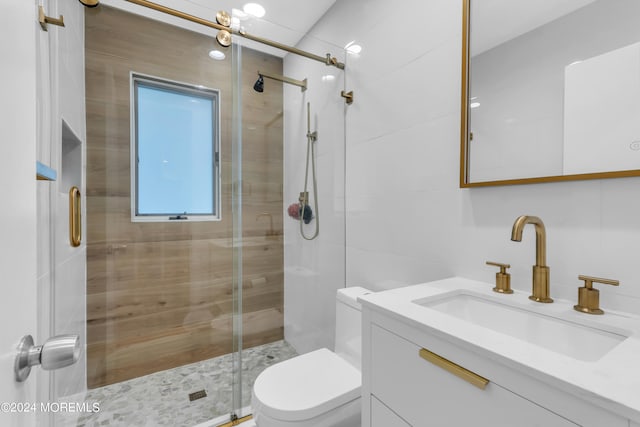 bathroom featuring tile walls, vanity, toilet, and walk in shower