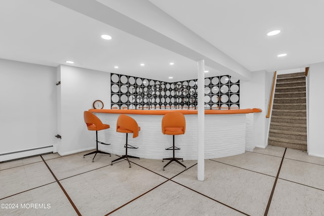 bar featuring tile patterned flooring and baseboard heating