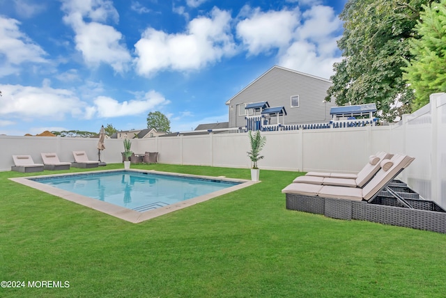 view of pool with a yard