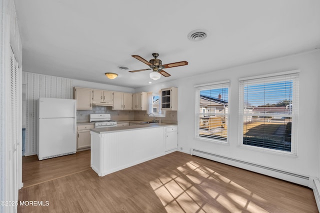 kitchen with white appliances, visible vents, a baseboard radiator, glass insert cabinets, and light countertops