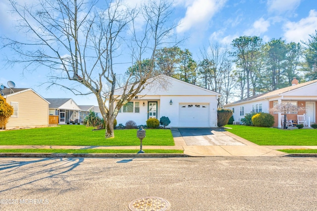 ranch-style home with concrete driveway, an attached garage, and a front lawn