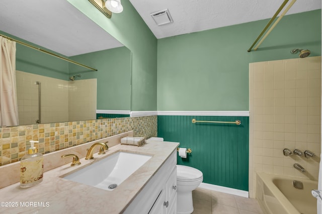 bathroom featuring a wainscoted wall, shower / tub combo with curtain, visible vents, a textured ceiling, and tile patterned floors