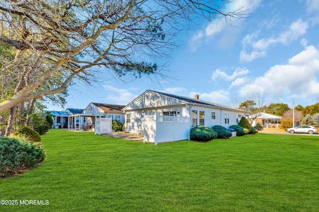 exterior space featuring a front yard and a chimney