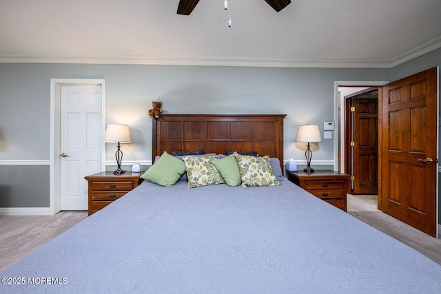 bedroom with light carpet, ceiling fan, baseboards, and crown molding