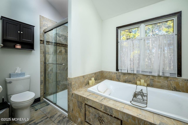 bathroom featuring vaulted ceiling, a stall shower, tiled tub, and toilet