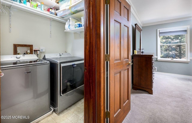 washroom featuring crown molding, washing machine and dryer, light carpet, laundry area, and baseboards