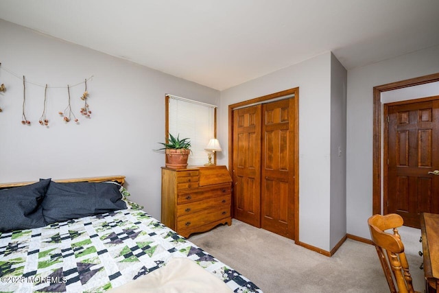 bedroom with light carpet, a closet, and baseboards