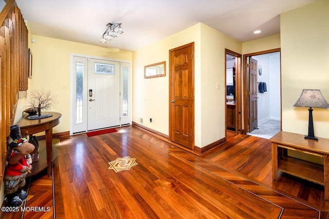 entrance foyer with baseboards and wood finished floors