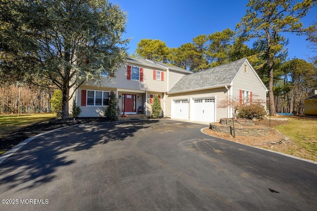 view of front facade with driveway and an attached garage