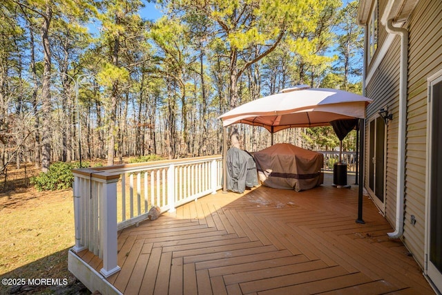 wooden deck with area for grilling and a gazebo