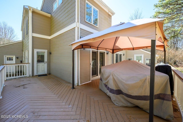 wooden terrace featuring a gazebo