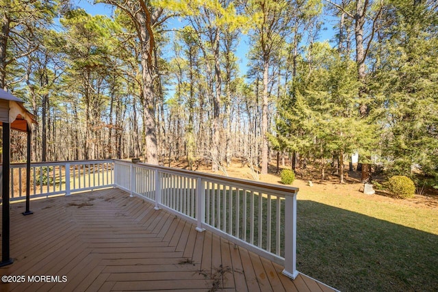 wooden deck featuring a lawn