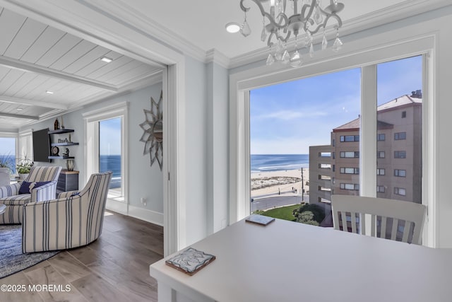 388 Ocean Ave N Unit 6D, Long Branch, NJ 07740 - dining room with wood finished floors, a chandelier, a water view, and ornamental molding
