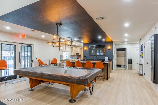 rec room featuring light hardwood / wood-style flooring, sink, and pool table