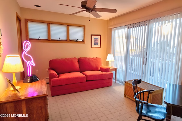 living room with a baseboard radiator and ceiling fan