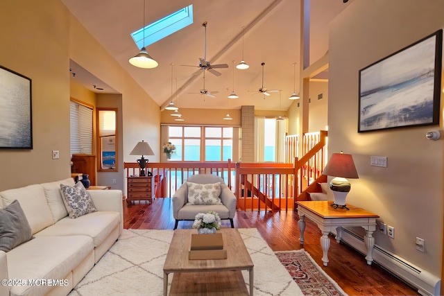 living room featuring a skylight, a baseboard radiator, high vaulted ceiling, and wood finished floors