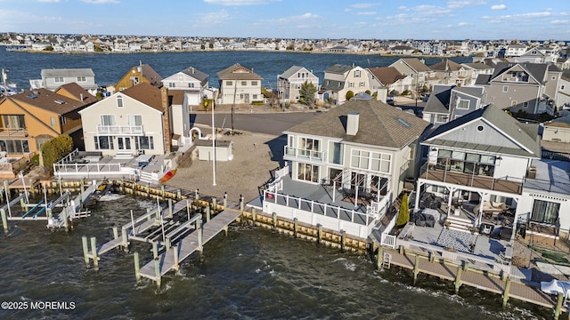 drone / aerial view featuring a water view and a residential view