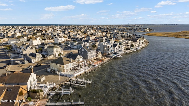 birds eye view of property with a water view and a residential view