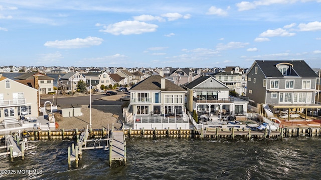 dock area featuring a residential view, a water view, a patio, and a balcony