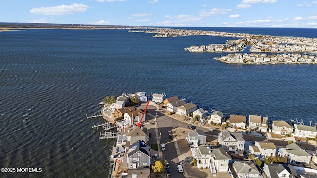 drone / aerial view featuring a residential view and a water view