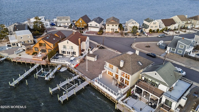 birds eye view of property with a residential view and a water view