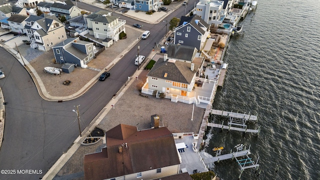 bird's eye view with a residential view and a water view