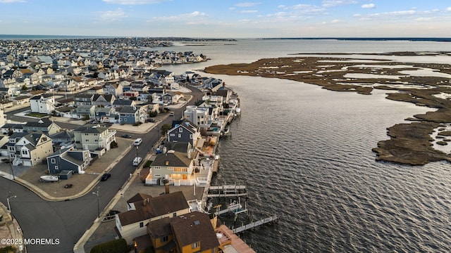 drone / aerial view featuring a water view and a residential view