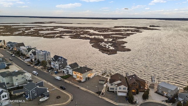 birds eye view of property with a water view and a residential view