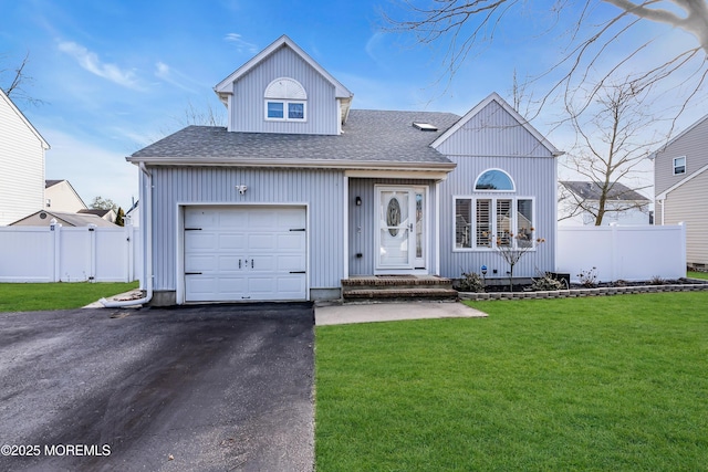 view of front of home featuring a front yard and a garage