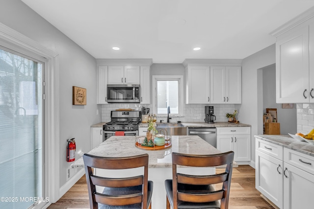 kitchen featuring sink, stainless steel appliances, and white cabinetry