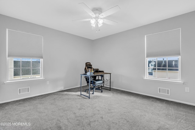 unfurnished office featuring ceiling fan and carpet floors