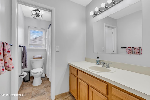 bathroom with toilet and vanity