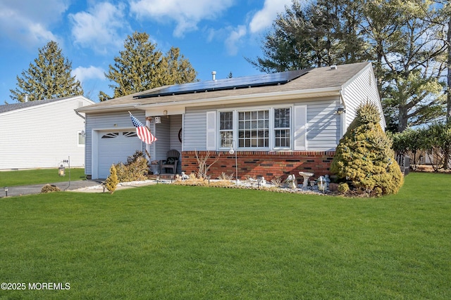 ranch-style house featuring a garage, solar panels, and a front lawn