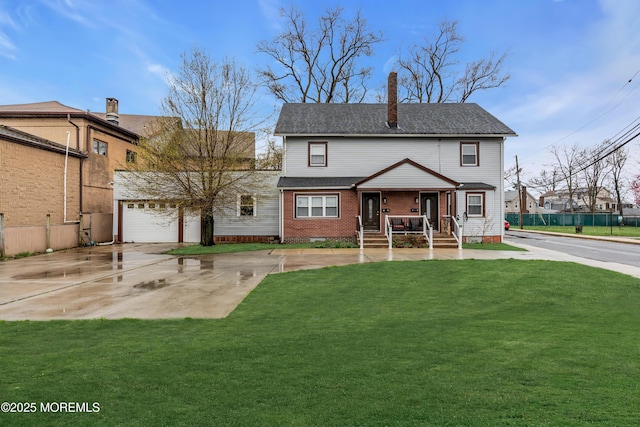 view of front facade with covered porch, a front yard, and a garage