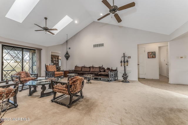 living room with high vaulted ceiling, ceiling fan, a skylight, and light colored carpet